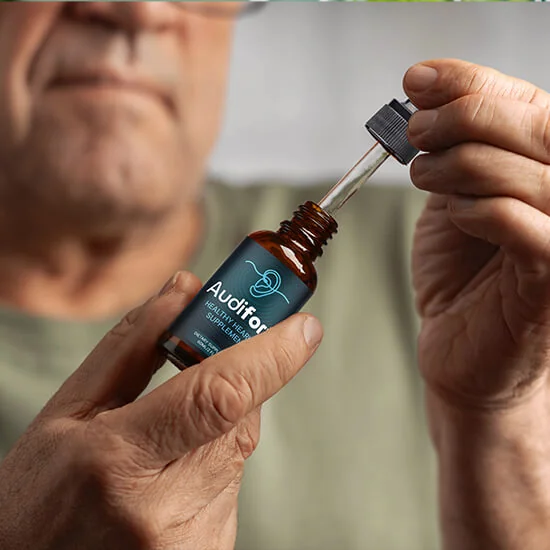 A person lifting the dropper out of an Audifort bottle, from the official website